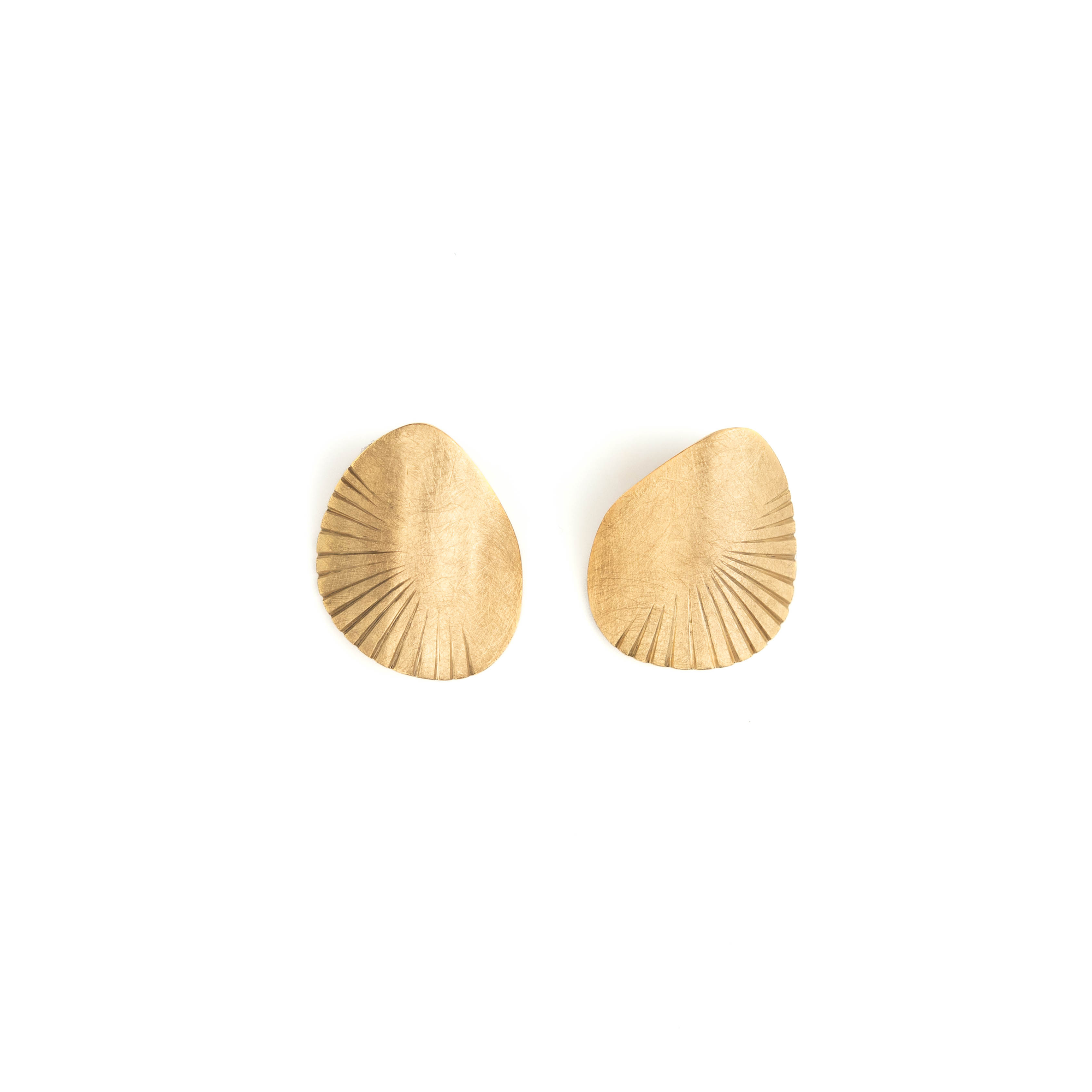 Pair of gold teardrop-shaped earrings on a white background